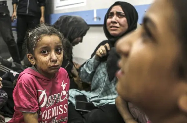 “Palestinian girl crying after a blast, sitting with her mother, face covered in dust and dirt”
