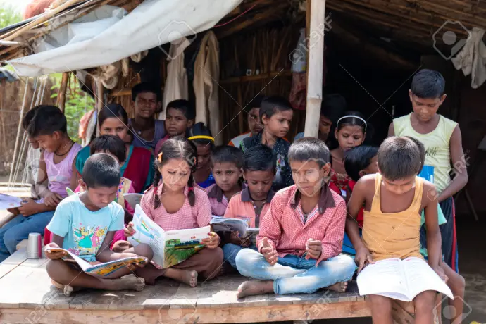 “Group of young children sitting with books on their laps in a small elementary school”